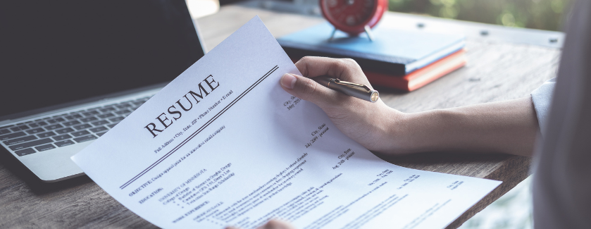 Person holding a resume.